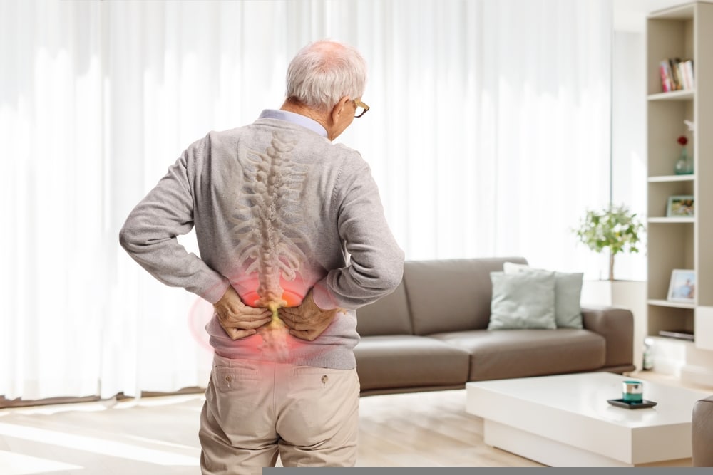 Rear,view,shot,of,an,elderly,man,in,pain,holding
