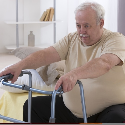 Senior,man,using,walking,frame