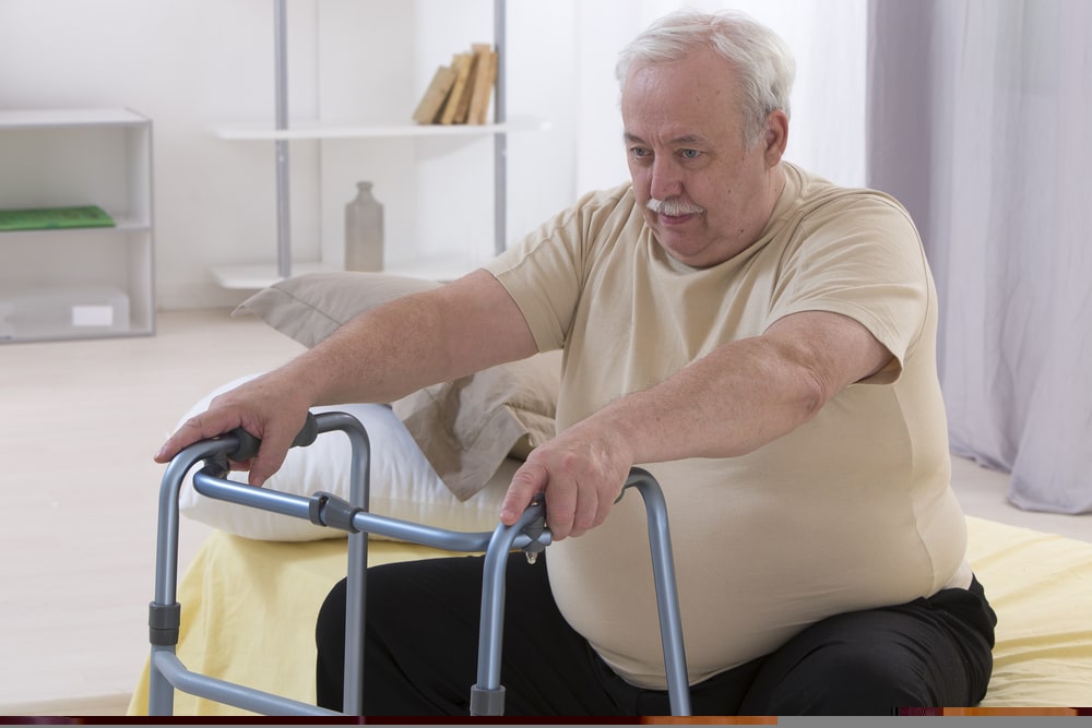 Senior,man,using,walking,frame