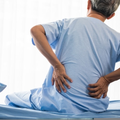 Senior,male,patient,having,back,ache,on,hospital,bed