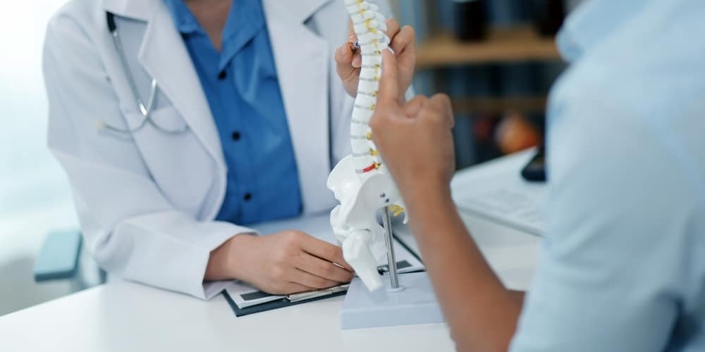 Orthopedists,holding,digital,tablet,and,pointing,at,model.,concept,of Orthopedists,holding,digital,tablet,and,pointing,at,model.,concept, back pain